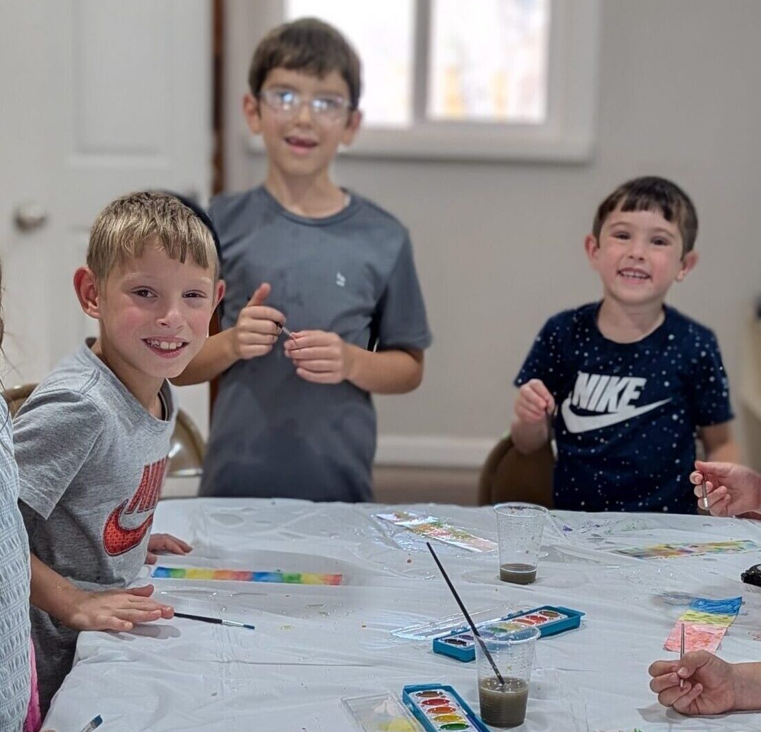 Group of Camp Shemeshaz counselors and staff members posing together indoors