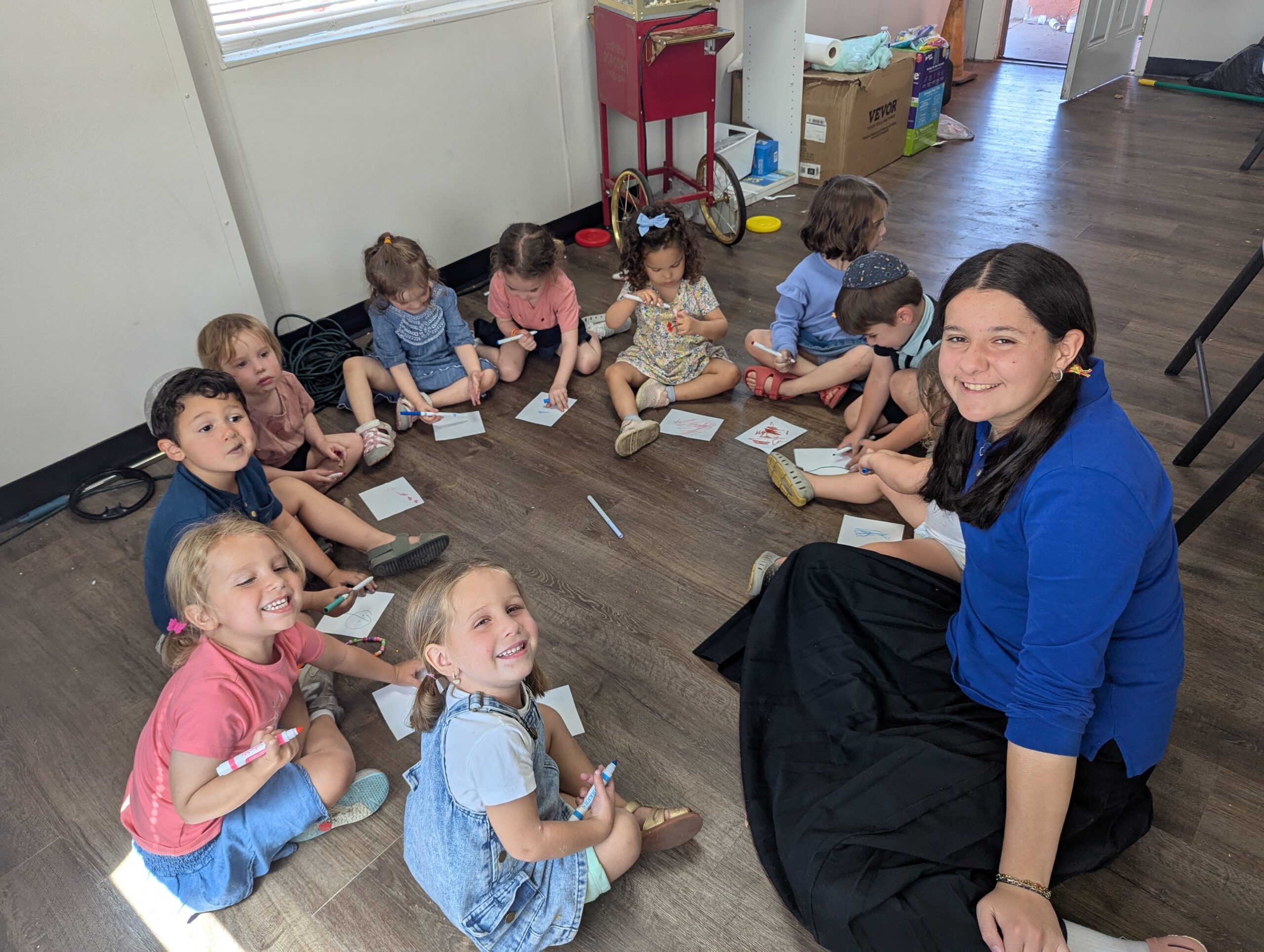 Teacher with kids doing artwork